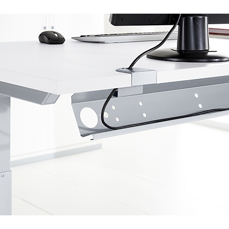 Close-up of a white desk with cable management. Gray cable tray, black cables, mouse, monitor.