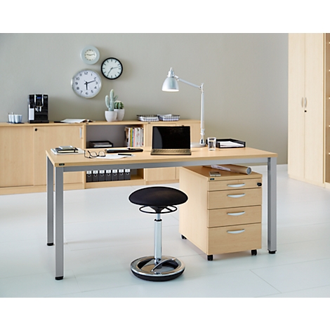Office setup with desk, chair, lamp, laptop, and cabinets. Clocks and a plant are visible on the wall.