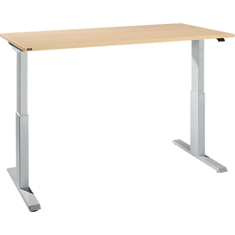 A height-adjustable desk, light wood top, silver metal legs.