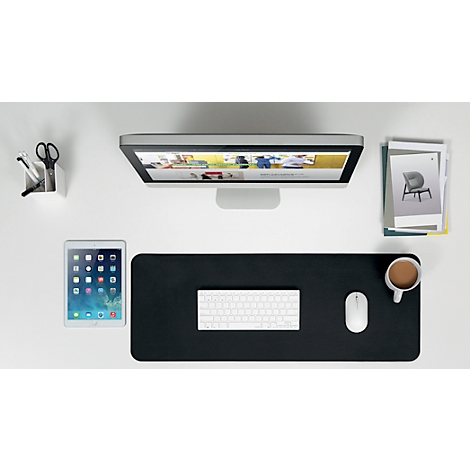 Overhead view of a desk with monitor, tablet, keyboard, mouse, coffee cup, pen holder and stack of papers.