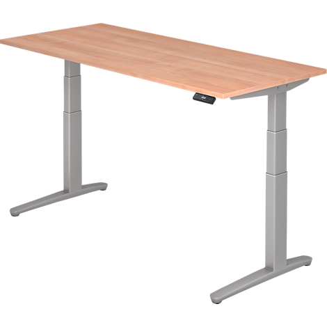 Height-adjustable desk with wooden top. The gray legs are T-shaped.