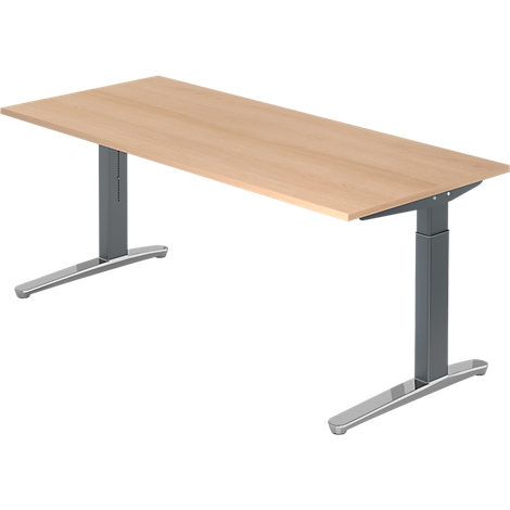 A light-colored desk standing on two gray, height-adjustable legs.