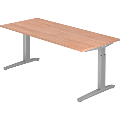 An adjustable height desk, with a rectangular wooden top and gray metal legs.