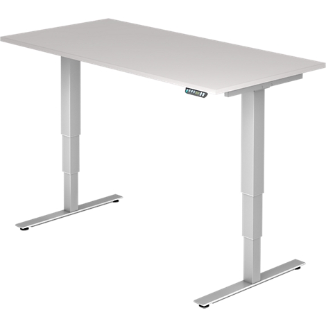 A white, height-adjustable desk with silver legs. A control unit can be seen on the table.