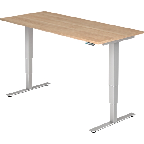 A height-adjustable desk with a wooden top and silver legs. Control panel on the edge.