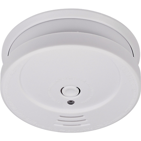 Détecteur de fumée rond, blanc, avec un bouton central et plusieurs petites fentes d'aération.