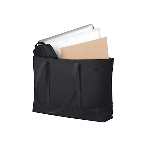 Sac fourre-tout noir avec contenu : ordinateur portable, papier, bloc-notes. Poignées en haut, environnement neutre.