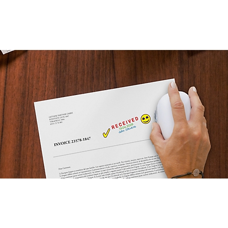 A hand operates a white mouse on a paper with "RECEIVED" printed on it.
