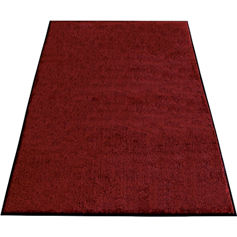 Dark red rug with black border. The shape is trapezoidal.