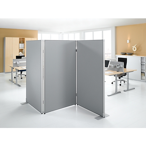 Gray room dividers in an office. Divided into three elements, with feet. Desks and windows in the background.
