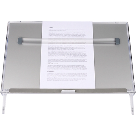 Transparent angled reading stand with paper. Text is on the paper.