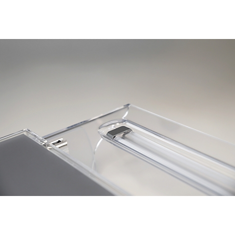 Close-up of a transparent lamp with built-in fluorescent tube. The lamp has a rectangular, clear plastic frame.