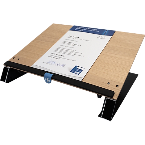 Wooden desk lectern with black paper holder. A sheet of paper with text rests on it.