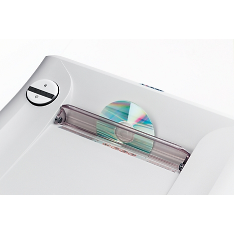 Close-up of a white device with a CD inserted.