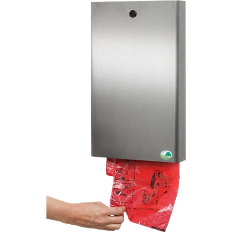 A person removes a red bag from a metal dispenser for dog waste bags.