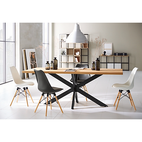 Dining table with four chairs in a modern interior, large lamp. Bright, minimalist furnishings.