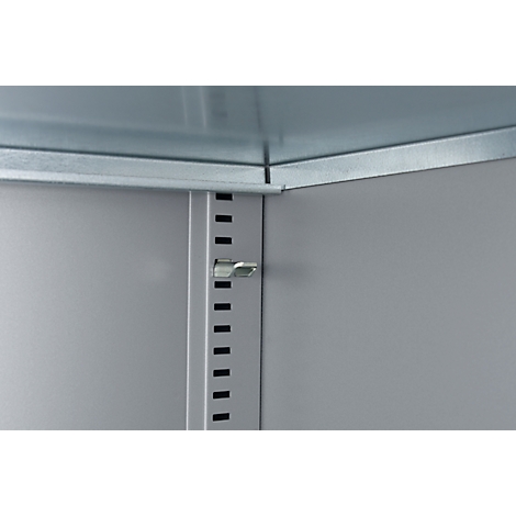 Detailweergave van een kastinterieur. Een zilveren kliksluiting op een grijze metalen wand, met een rij uitsparingen ernaast.