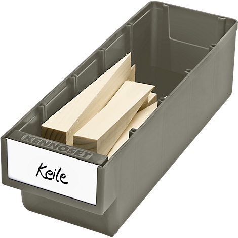 Grey plastic box with light wooden wedges, labeled with "Keile".