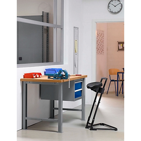 Workbench with vise and accessories. Toolbox and chair. Clock on the wall.