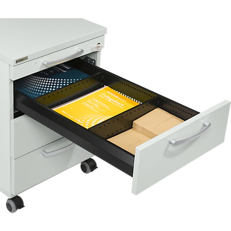 Open white filing cabinet drawer filled with paper, documents and yellow folders.