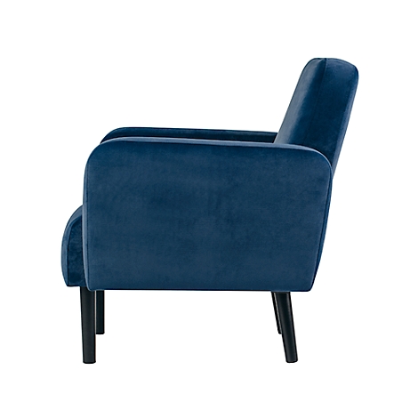 Blauwe fauteuil in profiel, zwarte poten, fluweelzacht oppervlak.