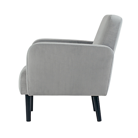 Lichtgrijze fauteuil in profiel met zwarte poten. Hij staat tegen een witte achtergrond.