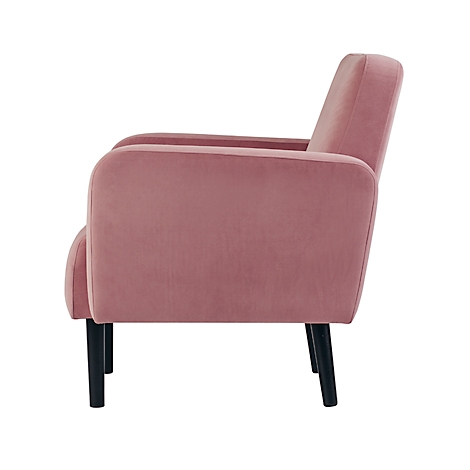 Een roze fluwelen fauteuil met zwarte houten poten, zijaanzicht.