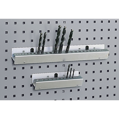 Metal drill bit holders with drill bits, attached to a gray pegboard.