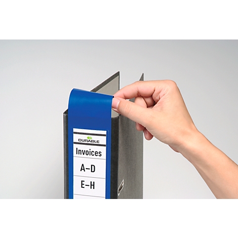 Hand reaching for a blue file folder label with 'Invoices'.