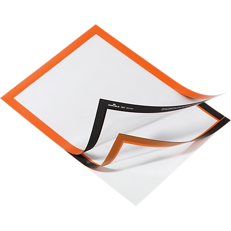 Silicone baking mat, white with orange border. One corner is lifted, revealing a second mat with a black border.