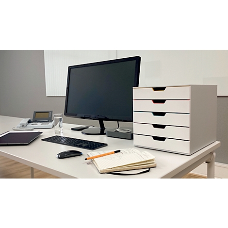 Desk with computer, drawers, keyboard, mouse, and notepad. Focus on the drawers.