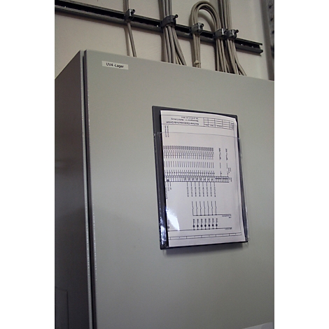 Grey switch panel with document in foil, cables and labeling.