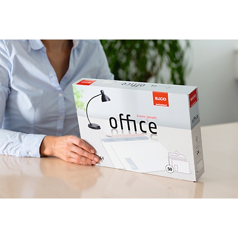A person holding a box with the word "office" on it.
