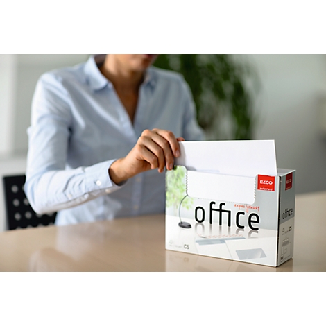 A person takes a sheet of paper from a paper box.