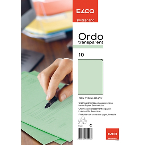 A hand writes with a black pen on green paper, next to product information.