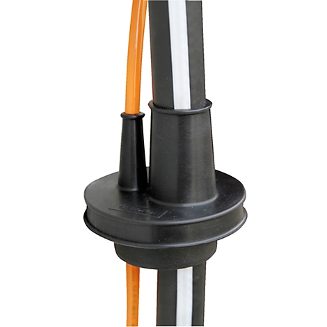 Detailed view of a black cable protector enclosing two pipes. An orange cable runs alongside the right pipe.