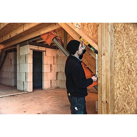 A man in work clothes, with a spirit level, in a shell.