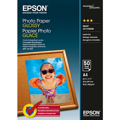 Corkboard with photo of a smiling child in a pool. Epson photo paper package, glossy surface.