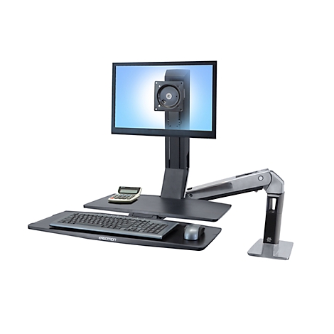 Desk set with monitor, keyboard, mouse and calculator. The monitor is held by an adjustable arm.
