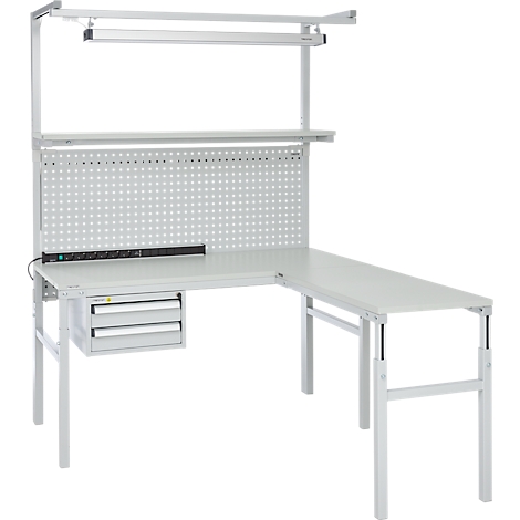 A grey corner workbench with a perforated wall, drawers and lighting.