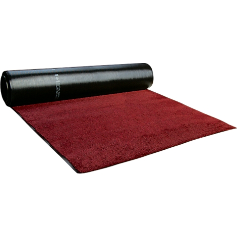 Alfombra roja desplegada. Rollo negro enrollado encima.