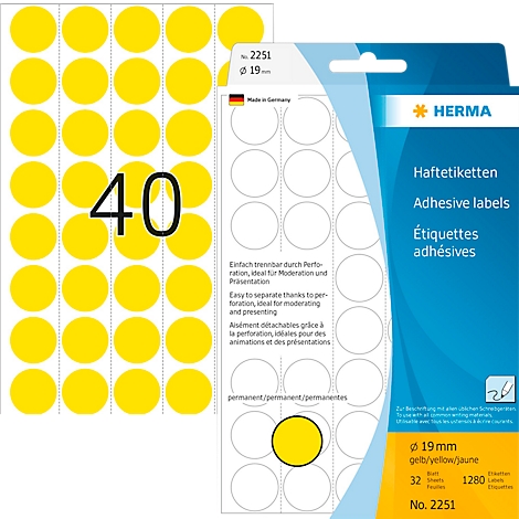 Étiquettes adhésives rondes jaunes avec emballage. L'emballage indique 'HERMA'.