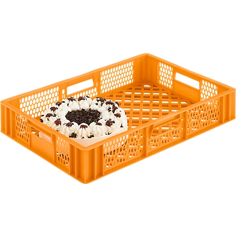 An orange cake container with a piece of cake topped with cream, cherries, and chocolate shavings.