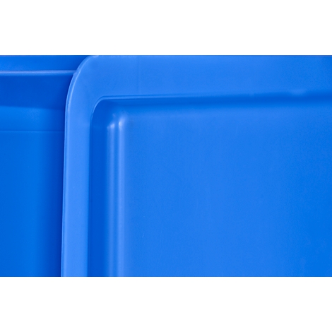 Close-up of bright blue plastic boxes. Rounded corners and edges stand out against the smooth surface.