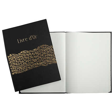 Un livre noir intitulé "Livre d'or" avec des détails dorés, à côté d'un livre ouvert avec des pages blanches.