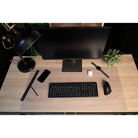Draufsicht auf einen Schreibtisch mit Monitor, Tastatur, Maus, Uhr, Smartphone und Lampe.