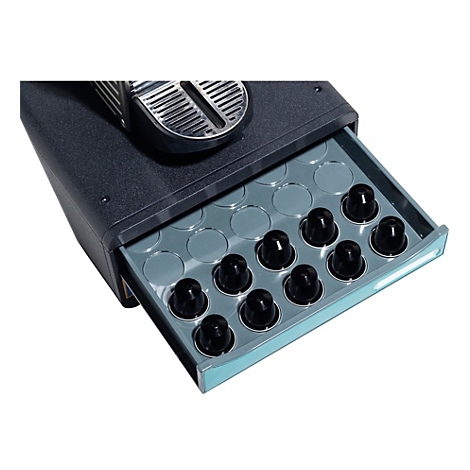 Ein detailreiches Foto zeigt die Schublade einer Kaffeemaschine, gefüllt mit schwarzen Kaffeekapseln.