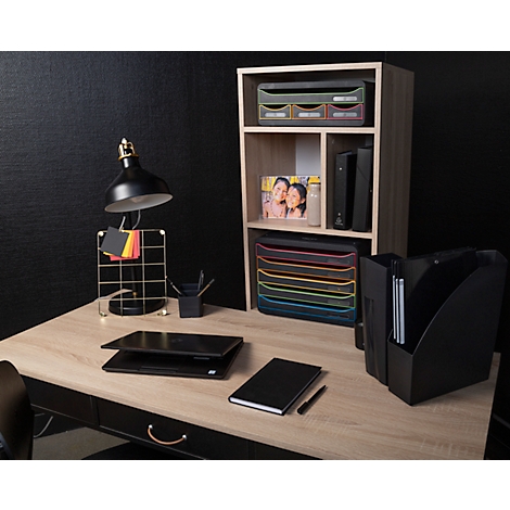Schreibtisch mit schwarzer Lampe, Laptop, Büchern, Ablagesystem, Regal und schwarzem Hintergrund.