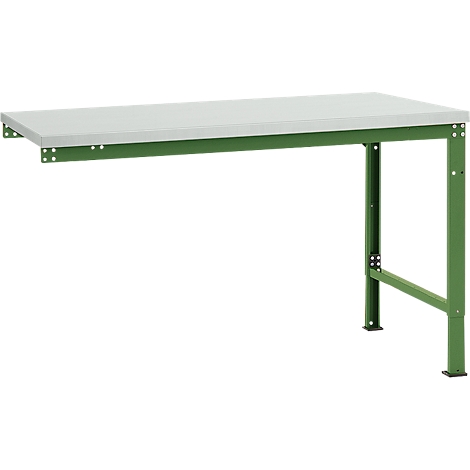 A green workshop table with a gray tabletop. The right leg stands on the ground, the left is attached to the wall.