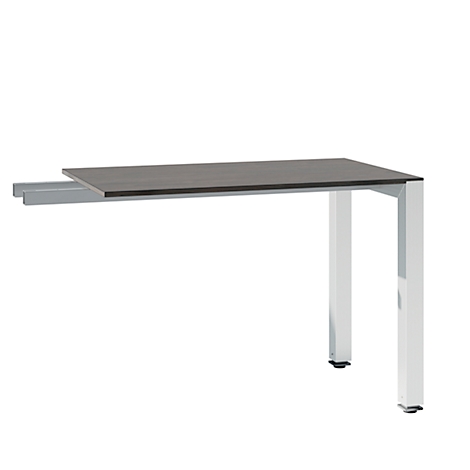 A desk with a dark tabletop supported by white metal legs. The tabletop is slightly extended.